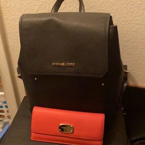 Black Michael Kors backpack and red wallet